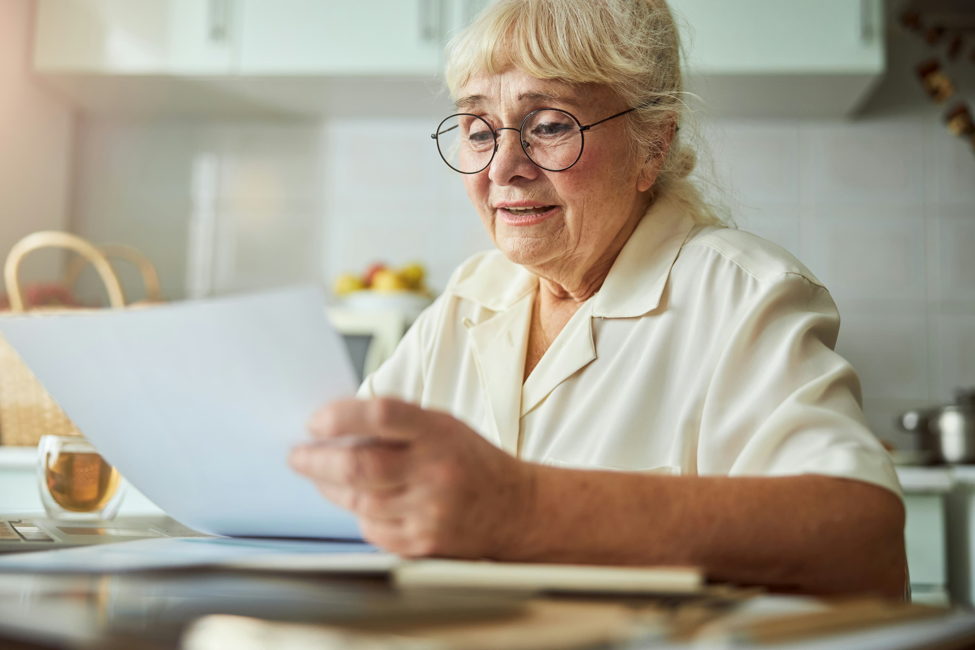 An older adult reviewing paperwork with a concerned family member, highlighting the legal aspect of elder fraud.
